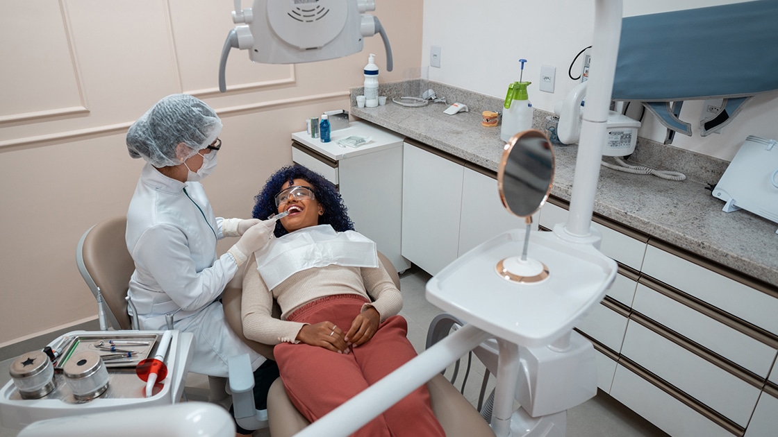 dentist cleaning patient's teeth